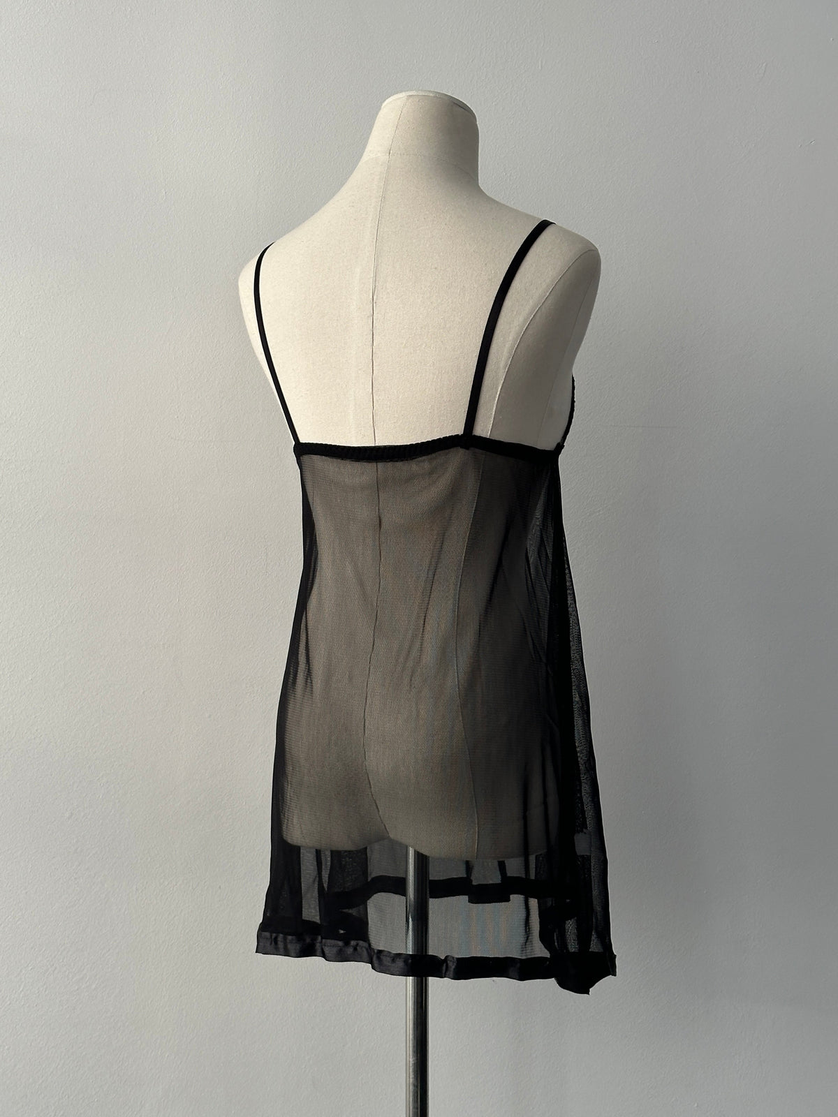 Vintage 2000s sheer sleeveless babydoll top, size small, featuring delicate fabric and vintage style details.