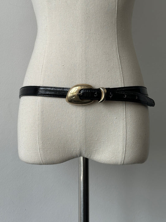 Jaeger 1990s patent leather sculptural buckle belt in black, featuring a distinctive sculptural buckle design and adjustable W30-35.