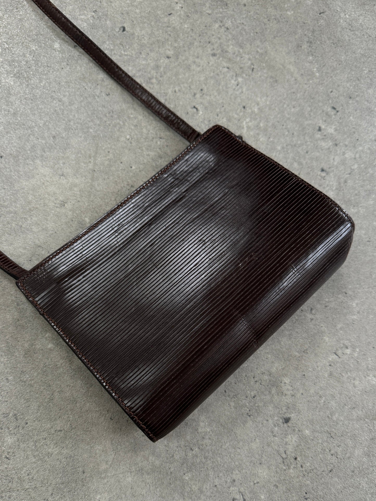 Giorgio Armani Le Collezioni 1990s leather crossbody bag with adjustable strap and classic design, in a neutral color.