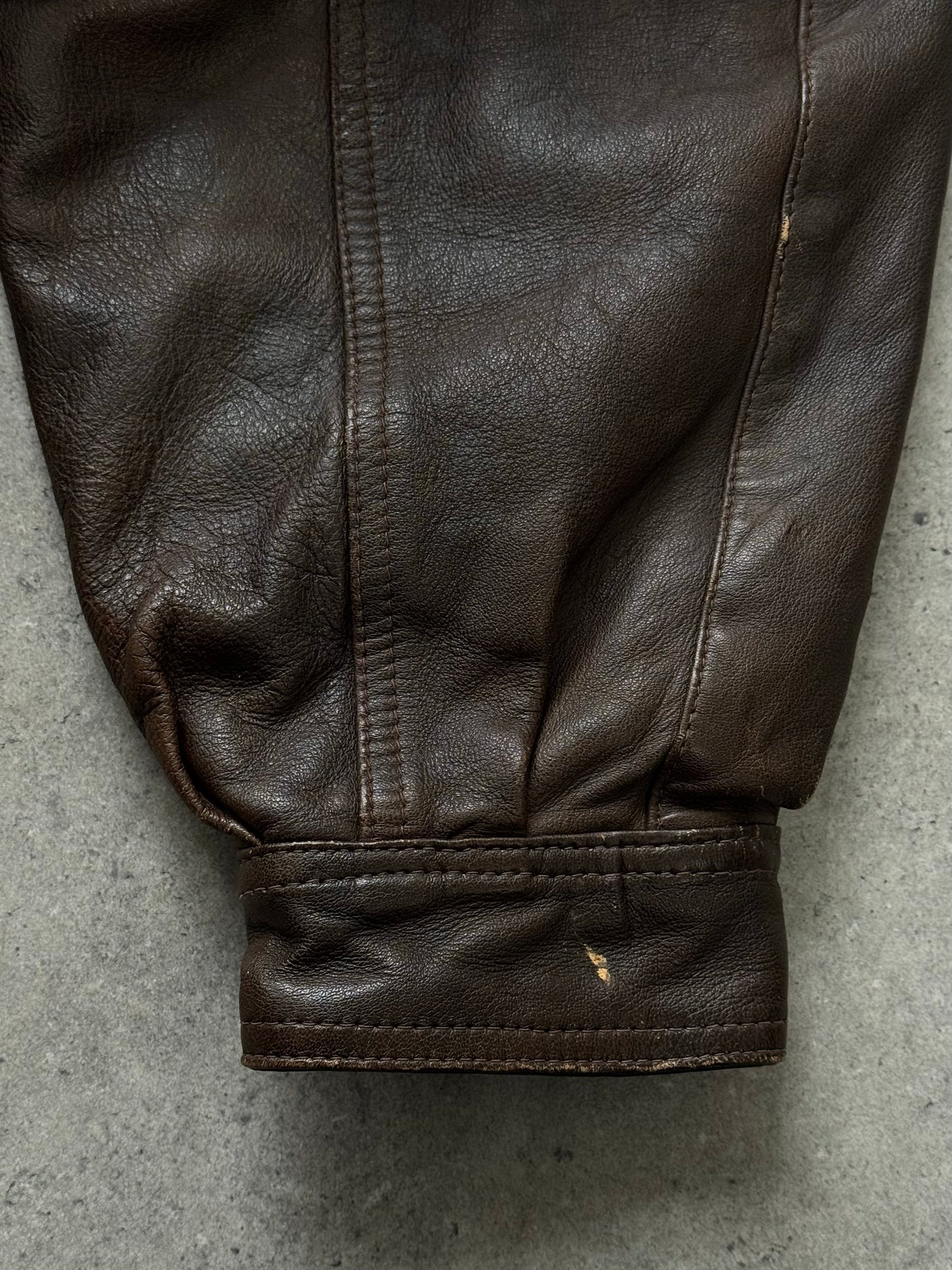 Vintage 1990s leather high neck bomber jacket, XL size, with classic collar and front zipper, crafted from brown leather.