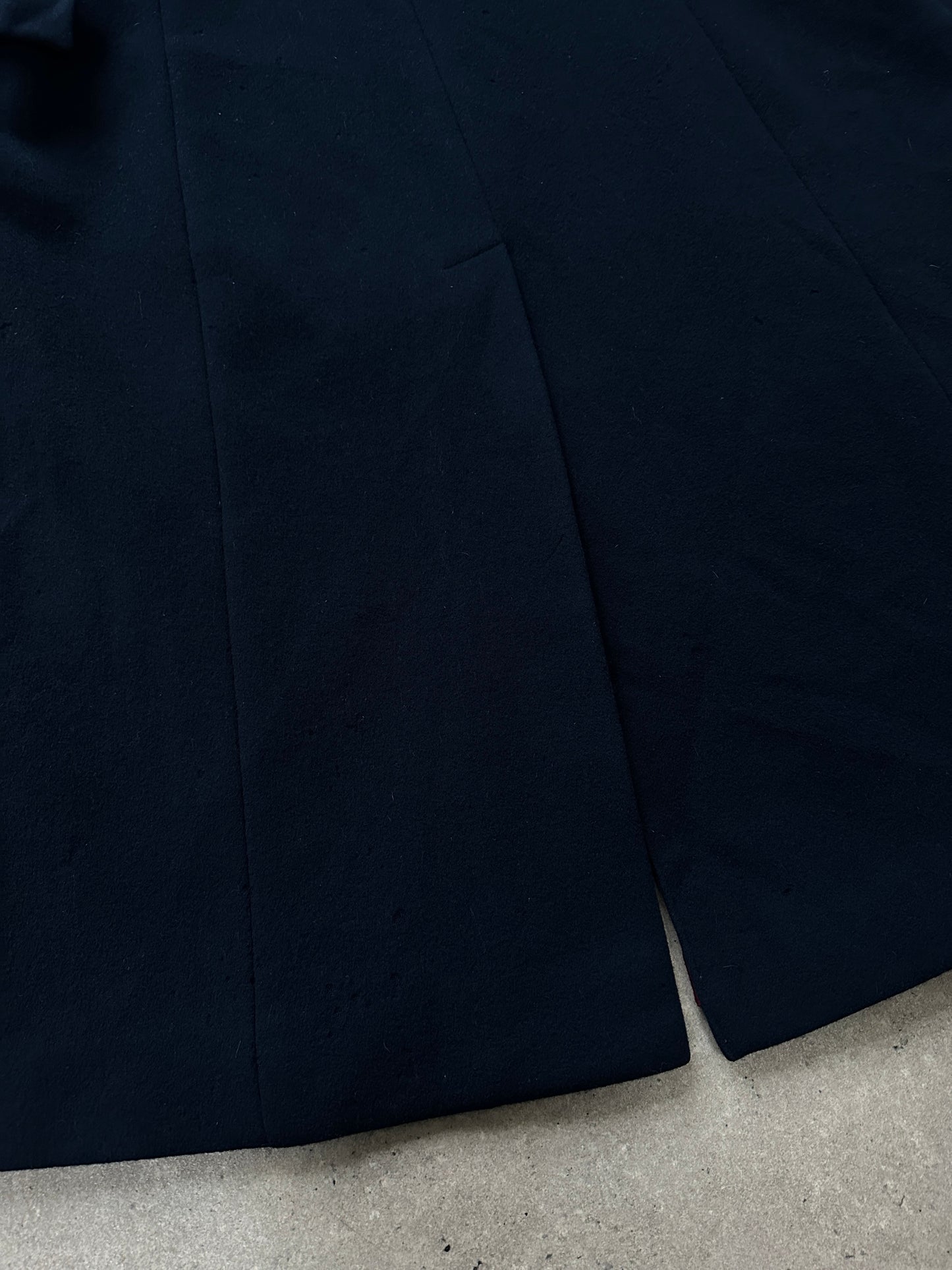 Christian Dior 1970s pure wool single-breasted coat in beige, displayed on a hanger with classic tailoring details.