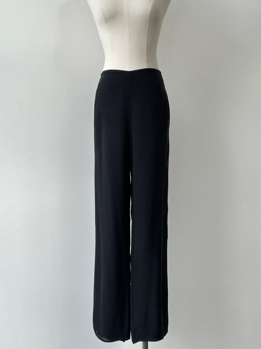Vintage 1990s pure silk wide leg trousers, size W30, with flowing fabric and high waist, styled in a classic vintage design.