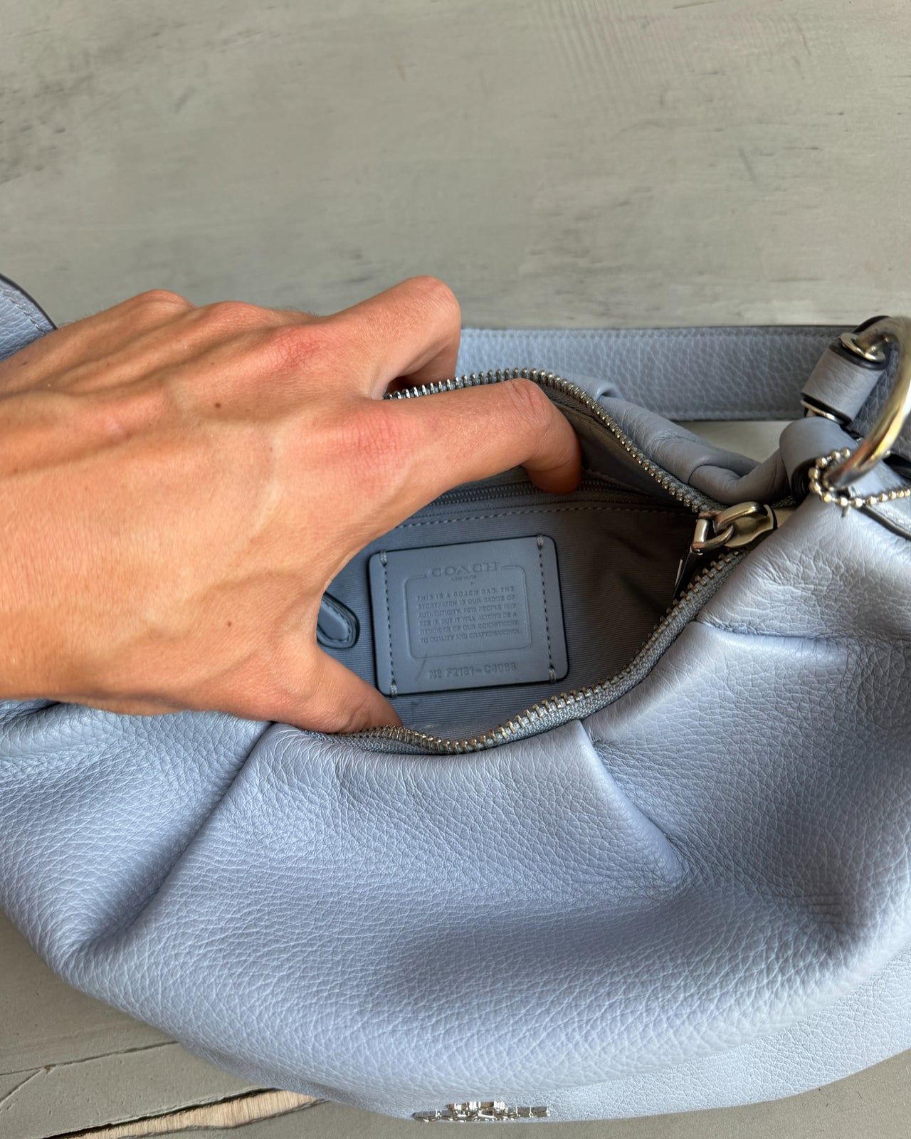 Coach Lilac Blue Leather Shoulder Bag-on a concrete background