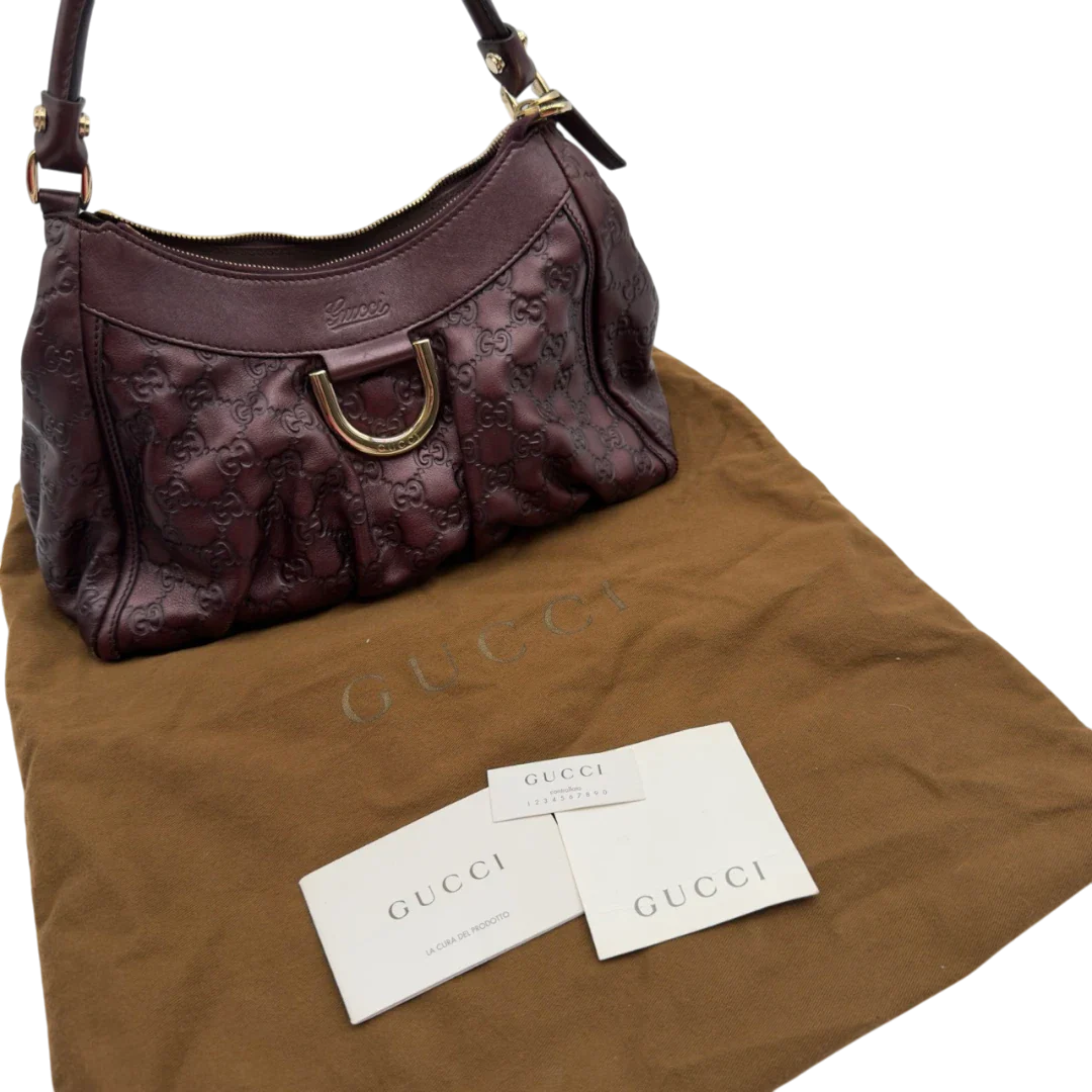 https://cdn.shopify.com/s/files/1/0564/9376/8855/files/Gucci_Schultertasche_D-Ring_medium_aus_Leder_monogram_lila_23.webp?v=1784283698