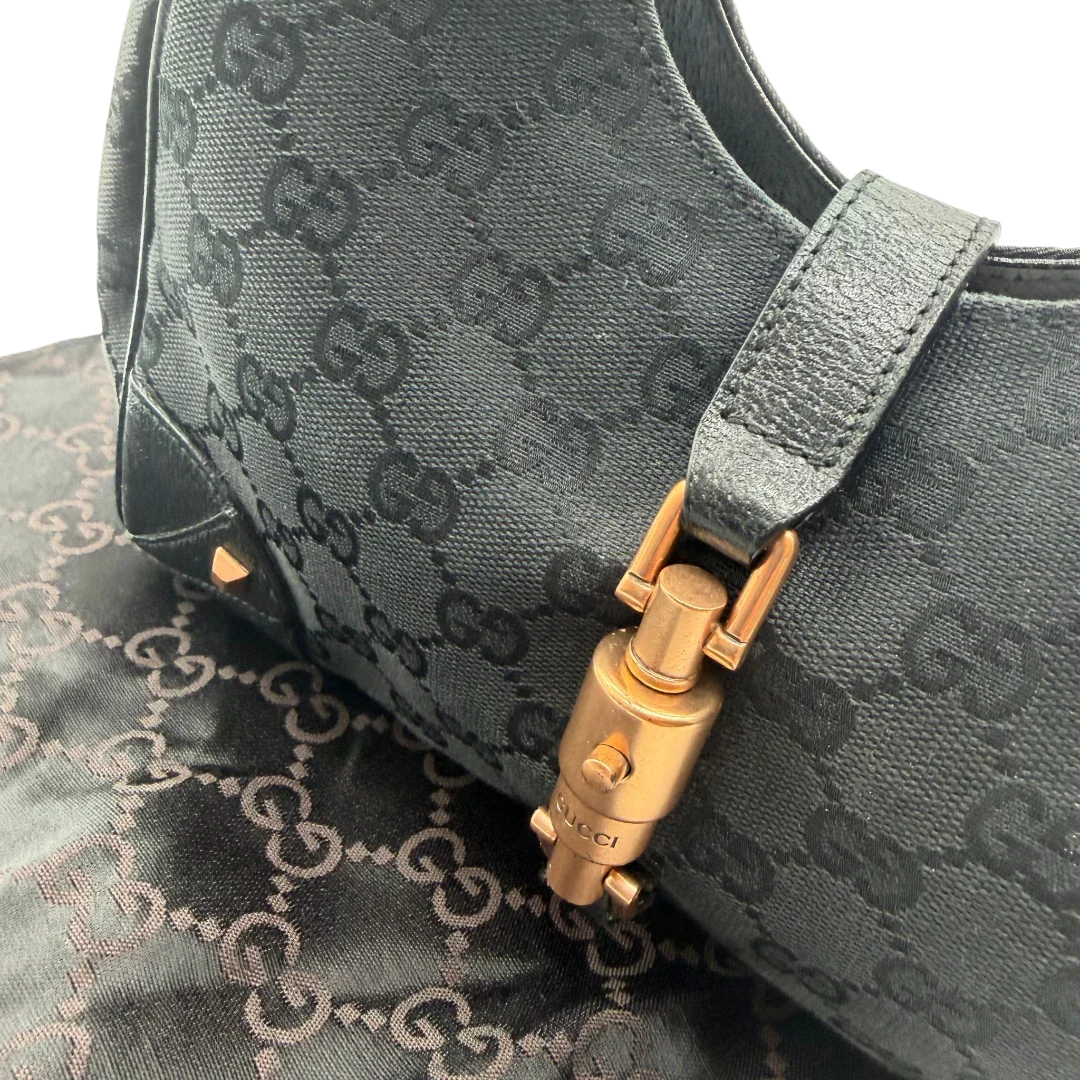 https://cdn.shopify.com/s/files/1/0564/9376/8855/files/Gucci_Schultertasche_New_Jackie_small_monogram_schwarz_vintage_GG_1487.webp?v=1772707241