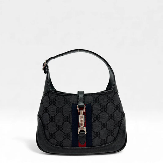 https://cdn.shopify.com/s/files/1/0564/9376/8855/files/Gucci_x_Balenciaga_Handtasche_Jackie_1961_mini_monogram_schwarz_vintage_GG_black_edition_handbag_9940.webp?v=1765456678