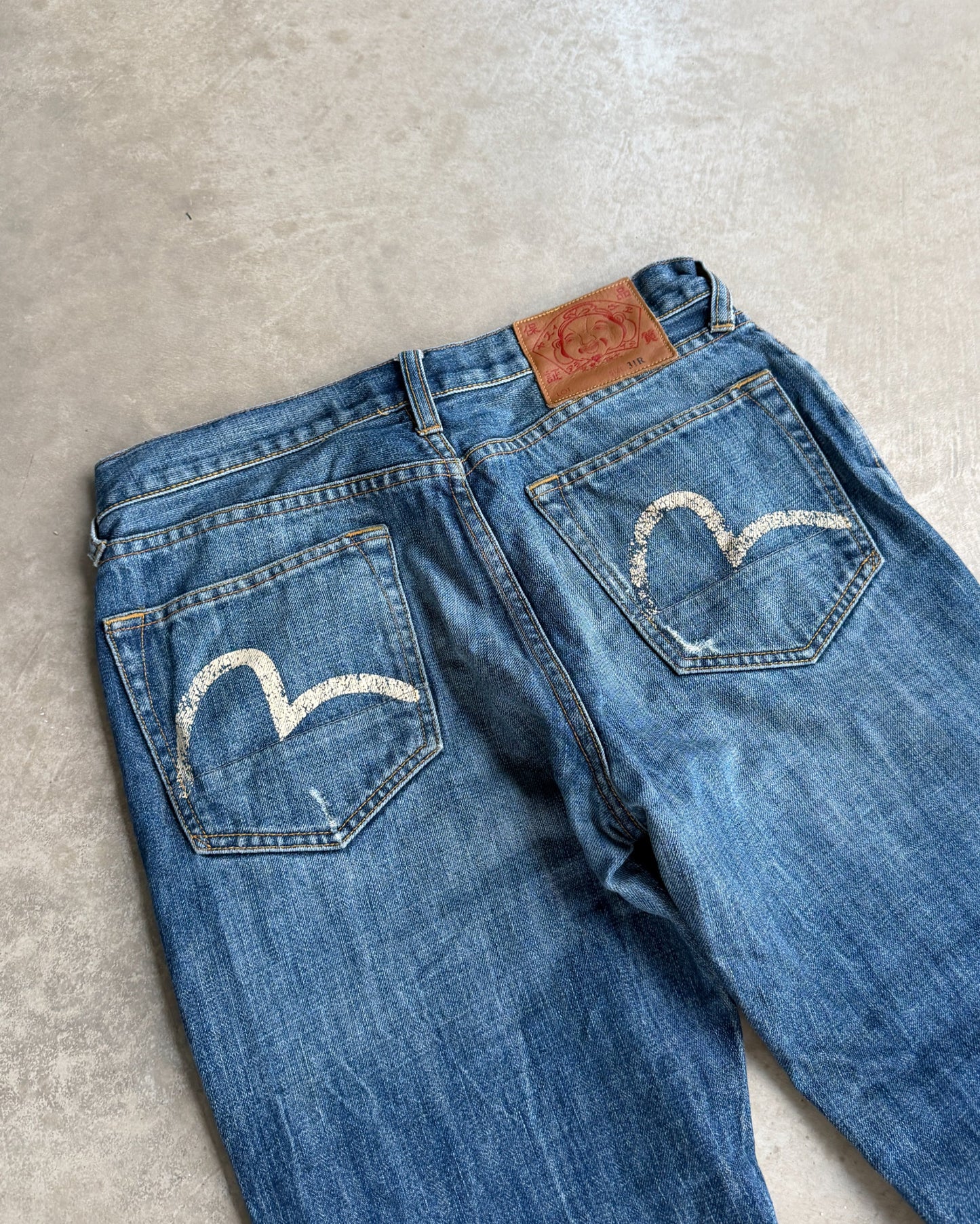 Vintage Evisu Jeans – W30–31-on a concrete background