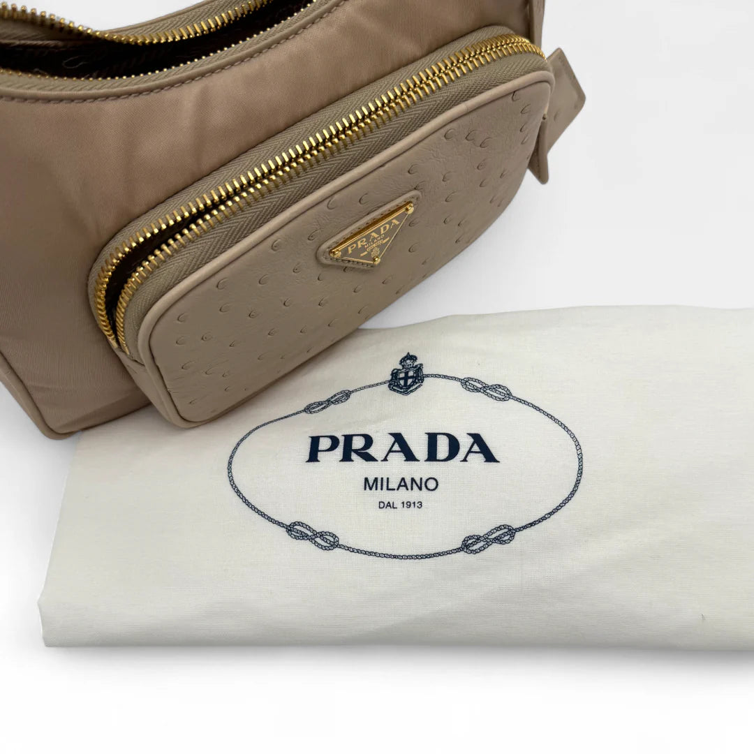 https://cdn.shopify.com/s/files/1/0564/9376/8855/files/Prada_Handtasche_Re-Nylon_Strauss_beige_handbag5066.webp?v=1761264094