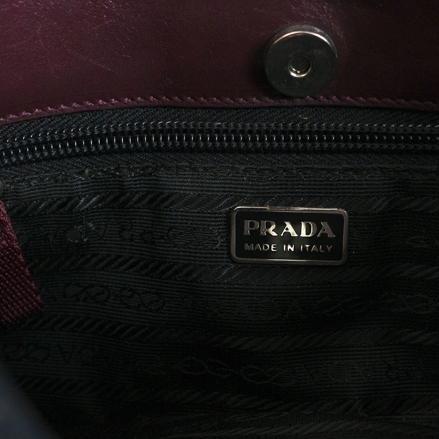 Prada SS 2000 Vitello Drive shoulder bag in burgundy leather with navy and green patent leather panels and perforated leather sections. Available at Artefact Archive.