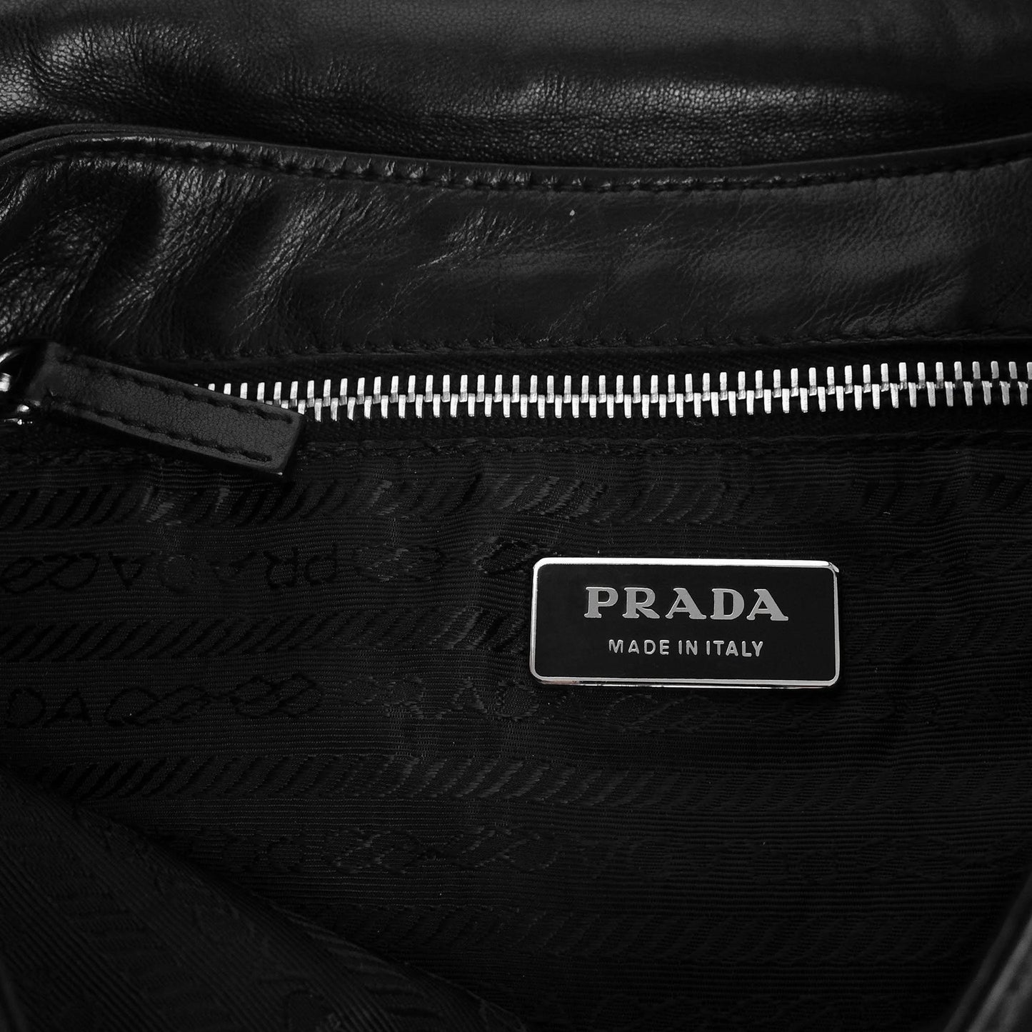Prada SS 2003 shoulder bag in black Nappa leather with metal hoop strap details. Available at Artefact Archive.