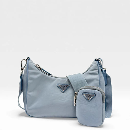 https://cdn.shopify.com/s/files/1/0564/9376/8855/files/Prada_Umhangetasche_Tessuto_Re-Nylon_2005_hellblau_crossbody_5827.webp?v=1765453661