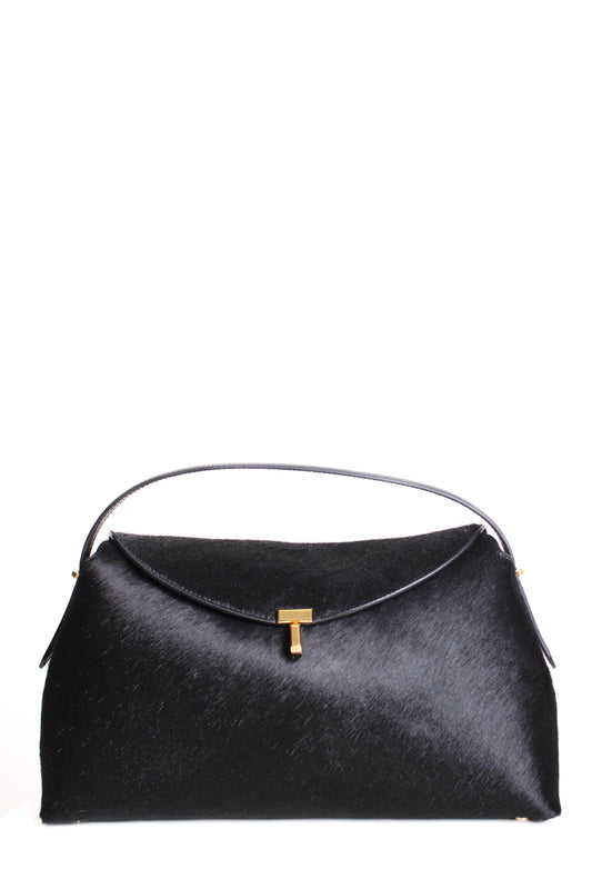 https://cdn.shopify.com/s/files/1/0770/3278/4192/files/Toteme_T_Lock_Pony_Hair_Bag_Black.jpg?v=1766441030