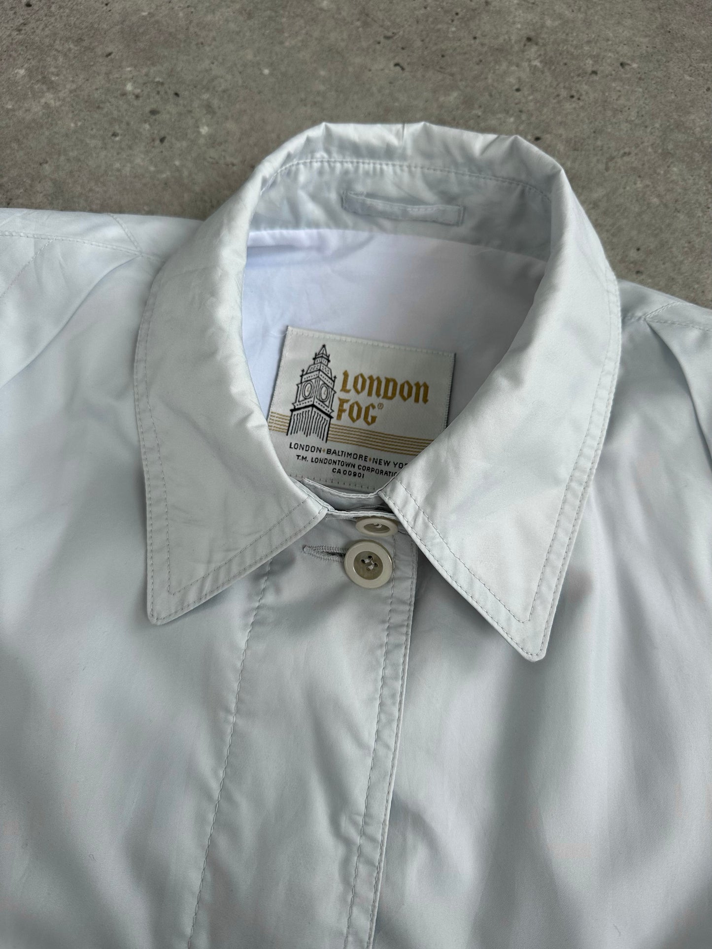 London Fog 1990s concealed placket trench coat in XL, beige color, classic design with double-breasted buttons and belt detail.