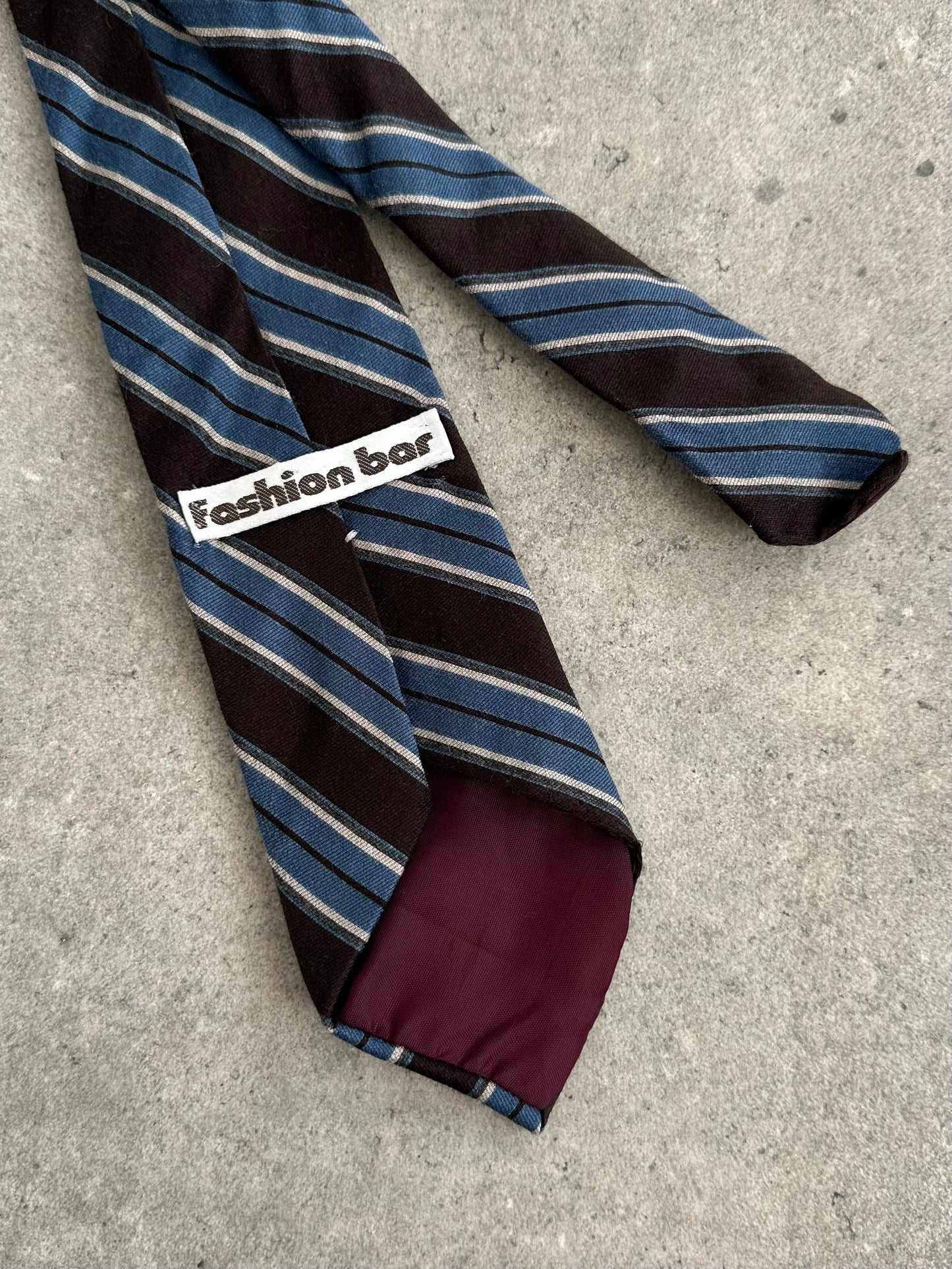 Vintage 1990s wool striped tie with classic pattern, featuring bold multicolor stripes on soft wool fabric.