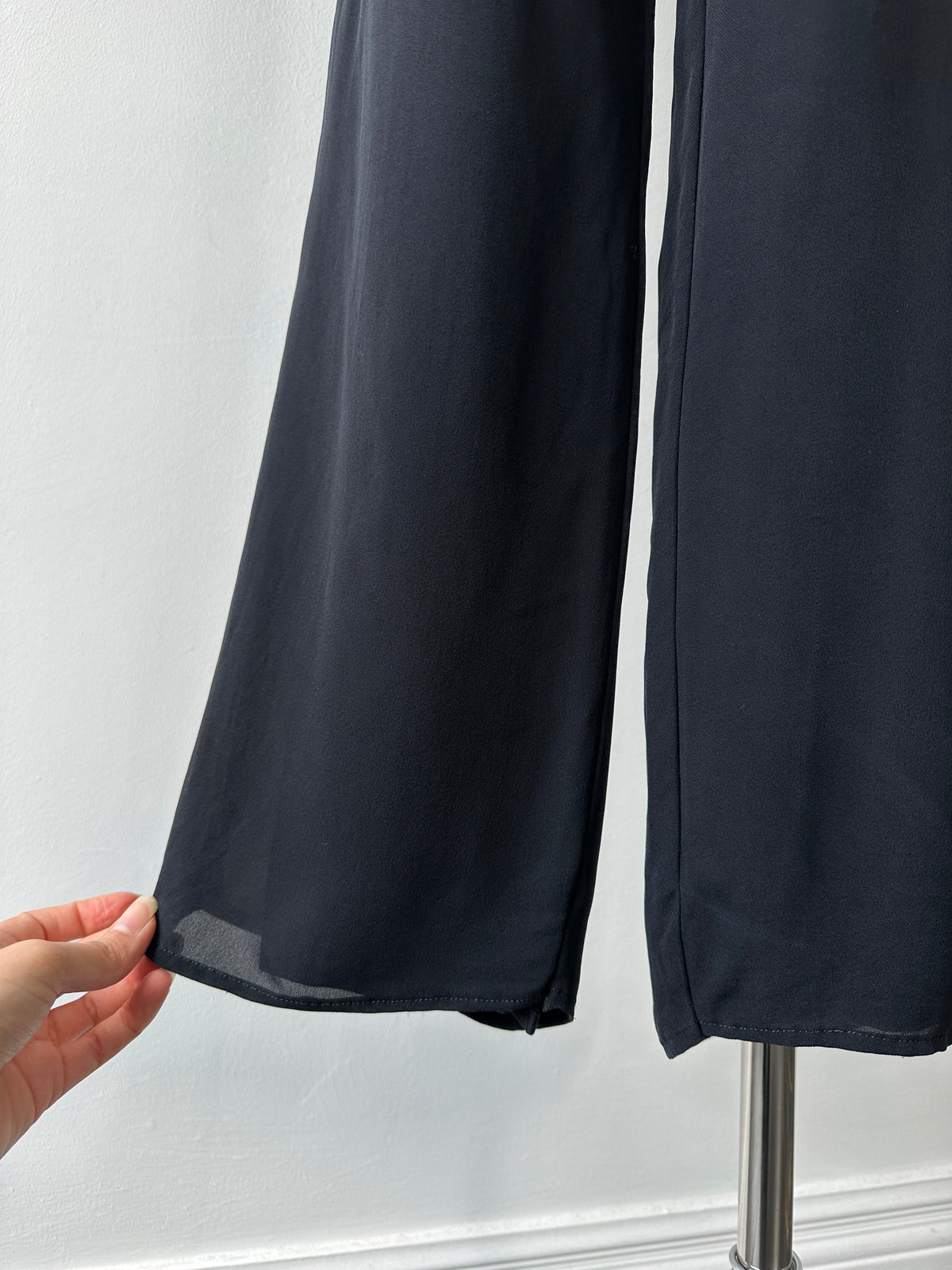 Vintage 1990s pure silk wide-leg trousers in size W30, showcasing flowing fabric and classic high-waisted design.