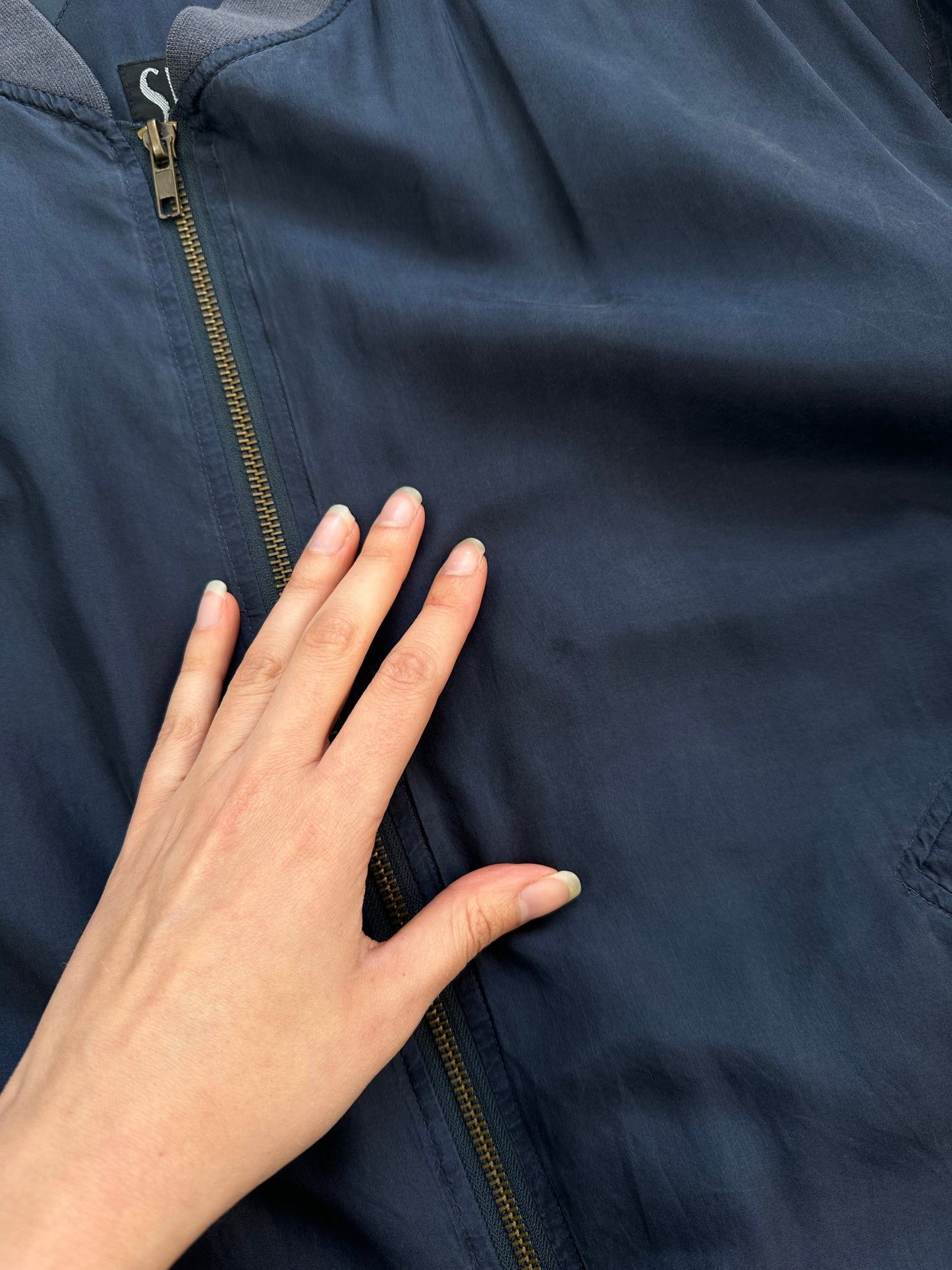 Vintage 1990s pure silk boxy bomber jacket, size large, with retro style and classic design, shown on a hanger.