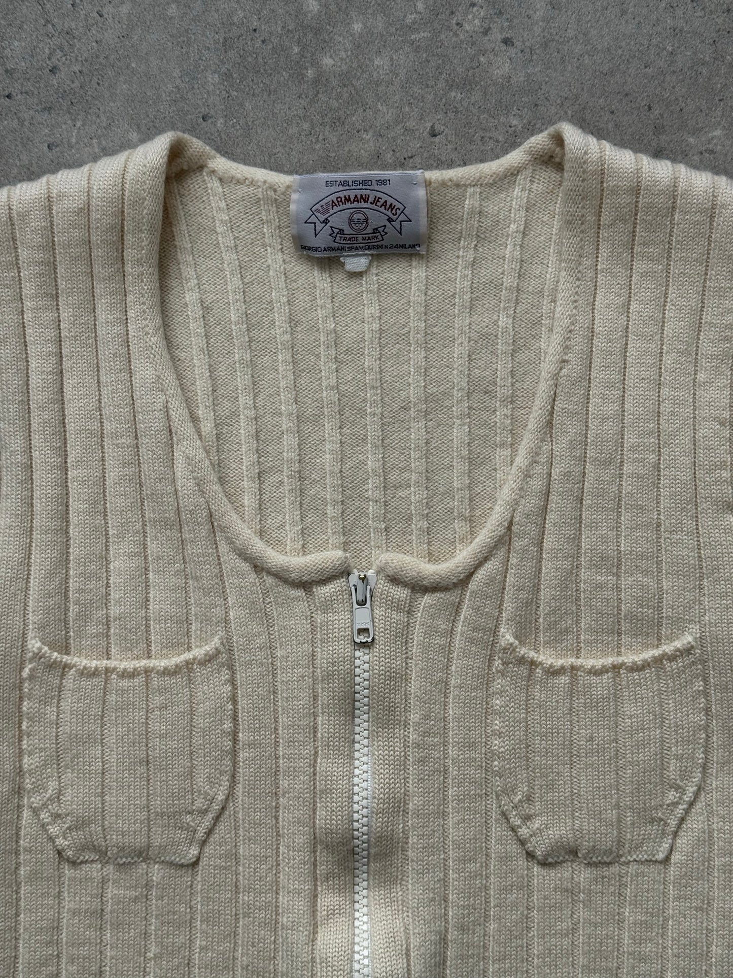 Armani Jeans 1990s pure wool knit top in XS, featuring a classic crewneck and ribbed texture, off-white color, and fitted style.