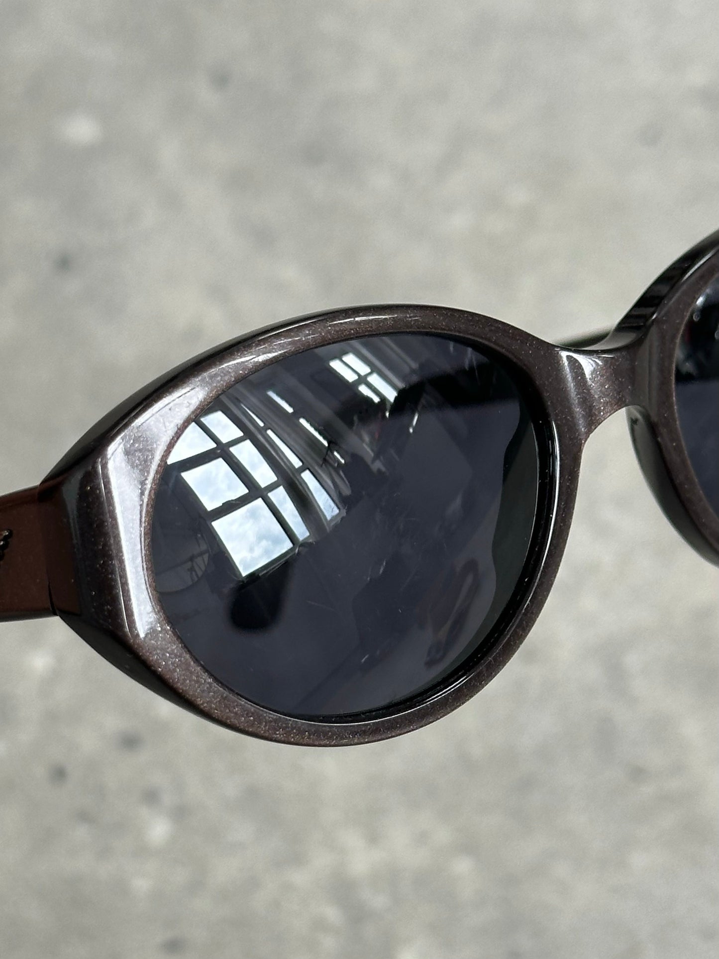 Emporio Armani 1990s oval logo sunglasses with black frames and dark tinted lenses, stylish and iconic eyewear.