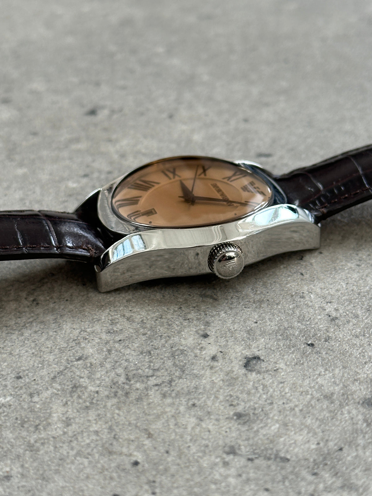 Emporio Armani 2000s leather quartz watch with black strap and silver dial, showcasing classic design and brand logo.