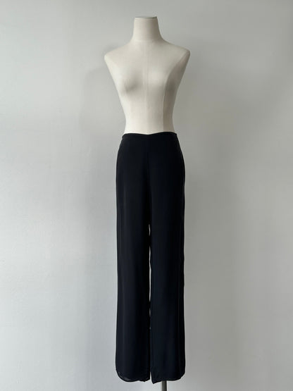 Vintage 1990s pure silk wide-leg trousers in size W30, showcasing smooth fabric and classic high-waisted style.