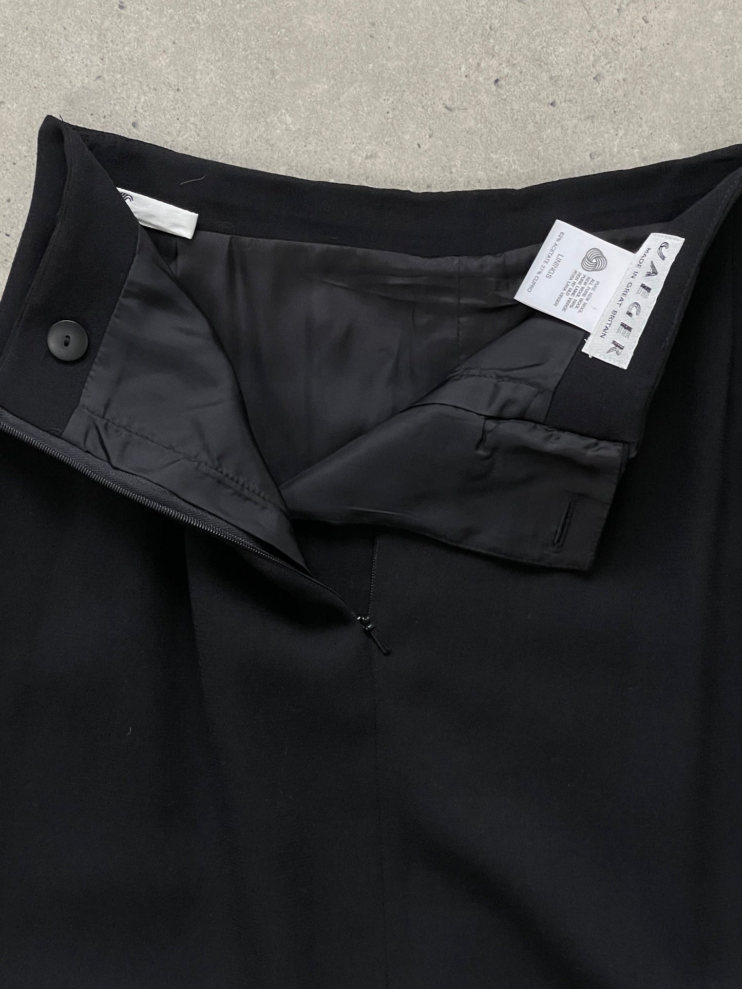 Jaeger 1990s pure wool side split maxi skirt in neutral tones, displayed on a hanger against a plain background.
