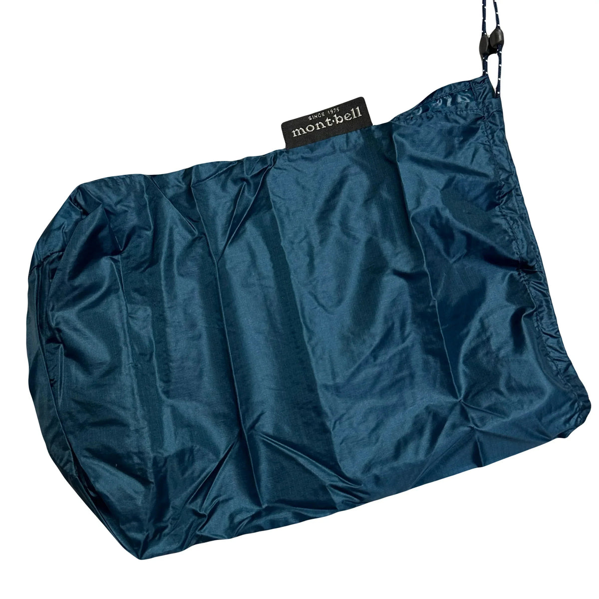 Blue Montbell storage bag for a Superior Down Parka Puffer Jacket