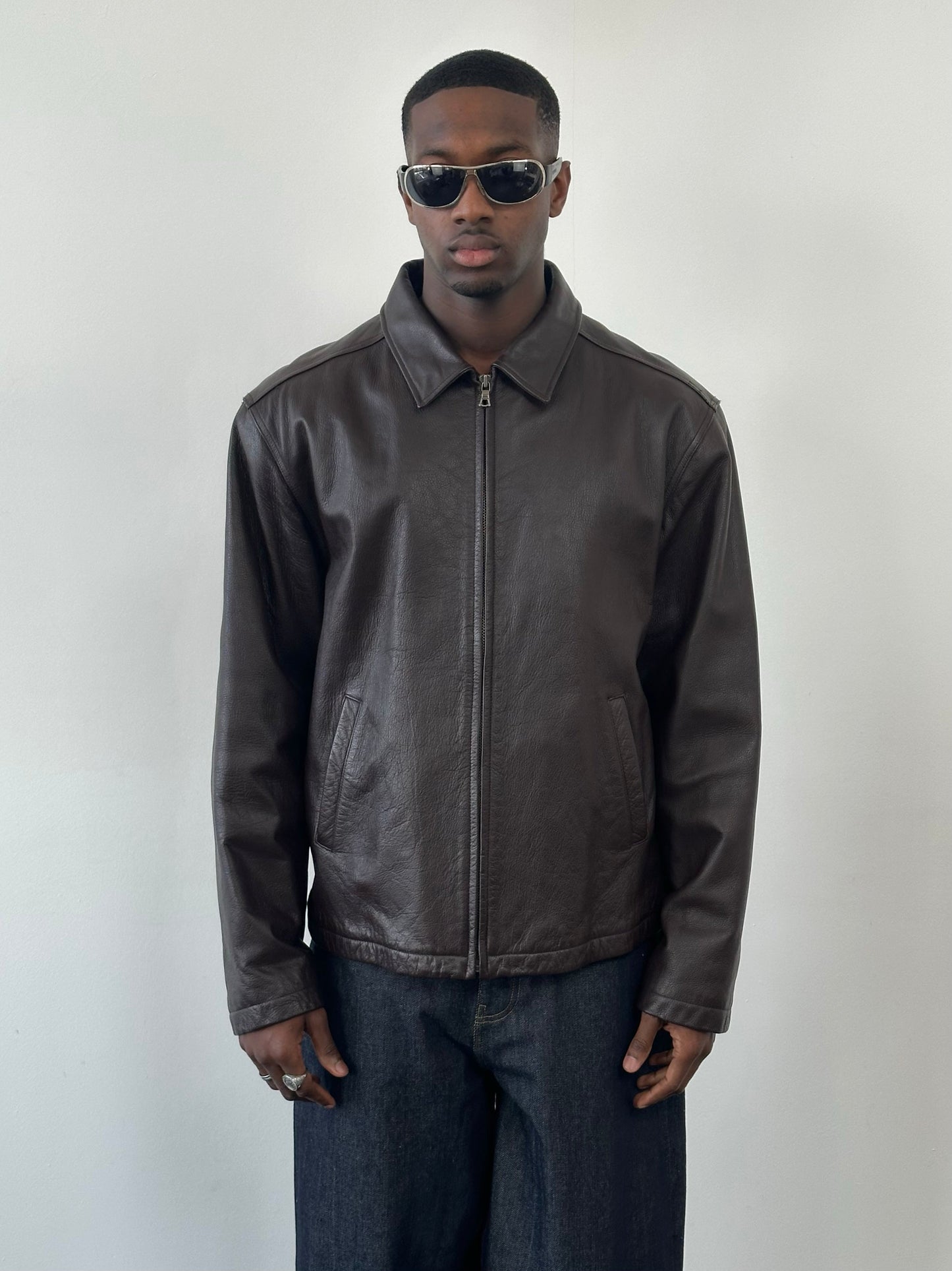 Vintage 1990s boxy leather jacket in XL, featuring minimal design, classic black leather, and vintage style.