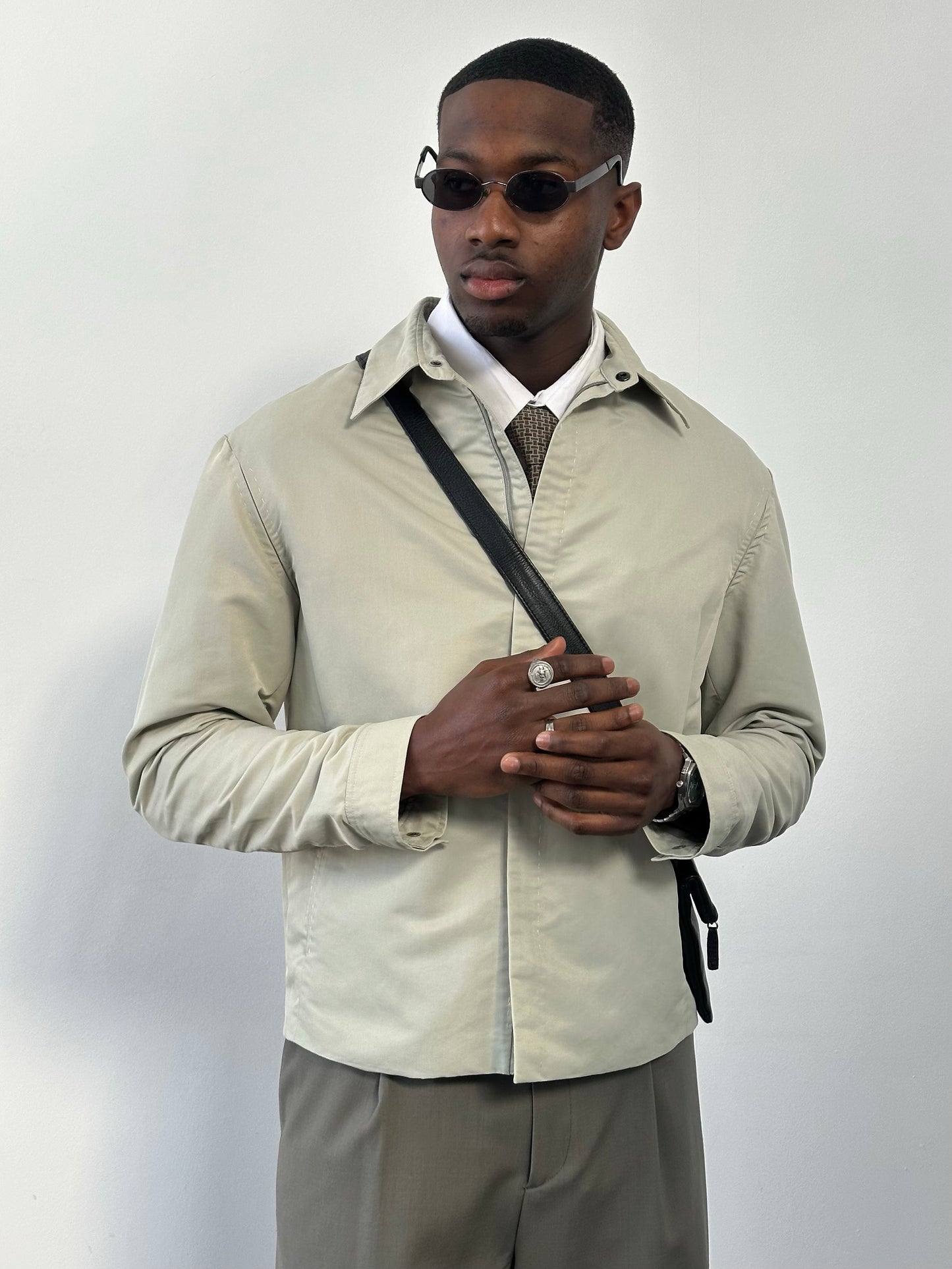 Gianfranco Ferre 1990s showerproof minimal jacket in size L, featuring sleek design and lightweight fabric, shown on a hanger.