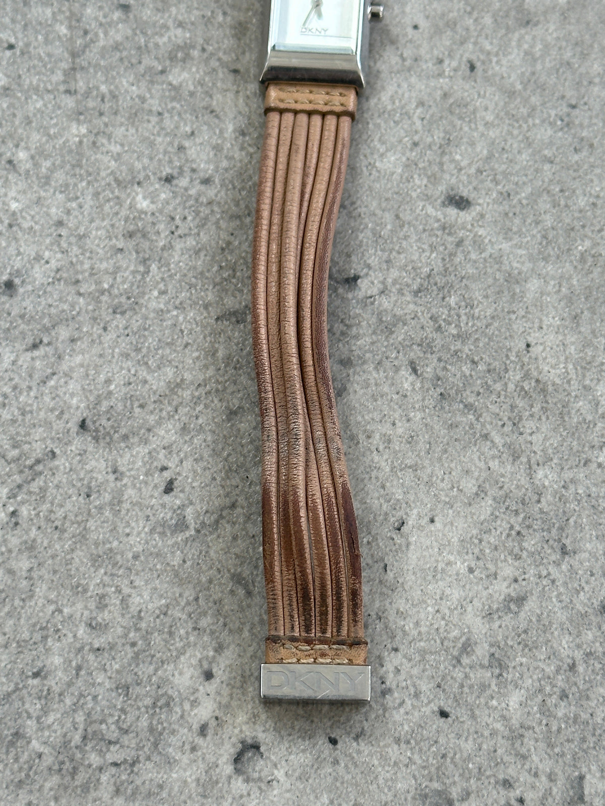 Donna Karran DKNY leather rectangular quartz watch with black dial and gold-tone case, vintage 2000s style.