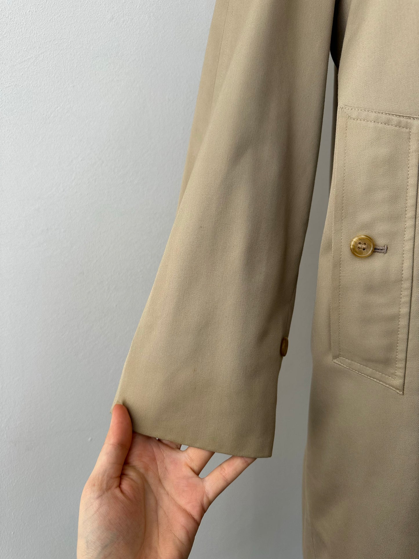 Burberry 1990s pure cotton high neck trench coat in beige, front view showing classic collar and belt detail.
