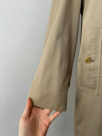 Burberry 1990s pure cotton high neck trench coat in beige, front view showing classic collar and belt detail.
