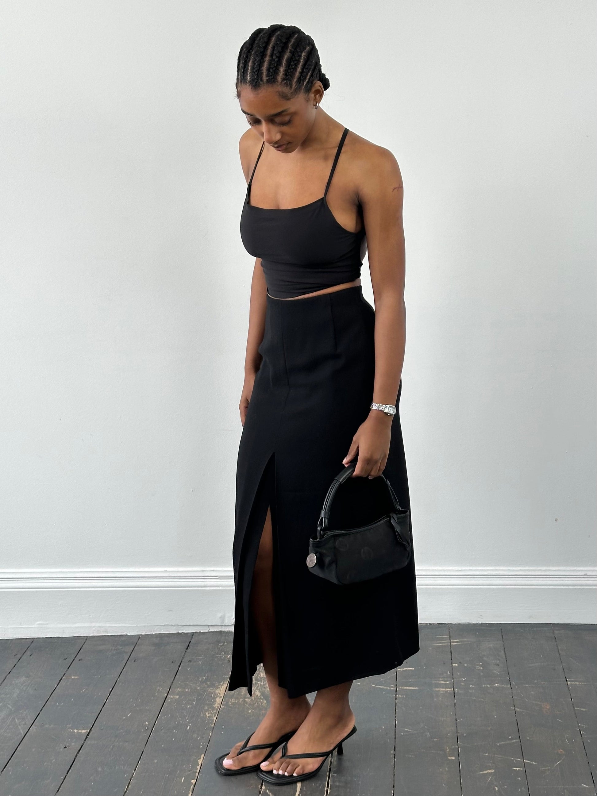 Jaeger 1990s pure wool side split maxi skirt in neutral tone, featuring a flowing silhouette and side slit detail.