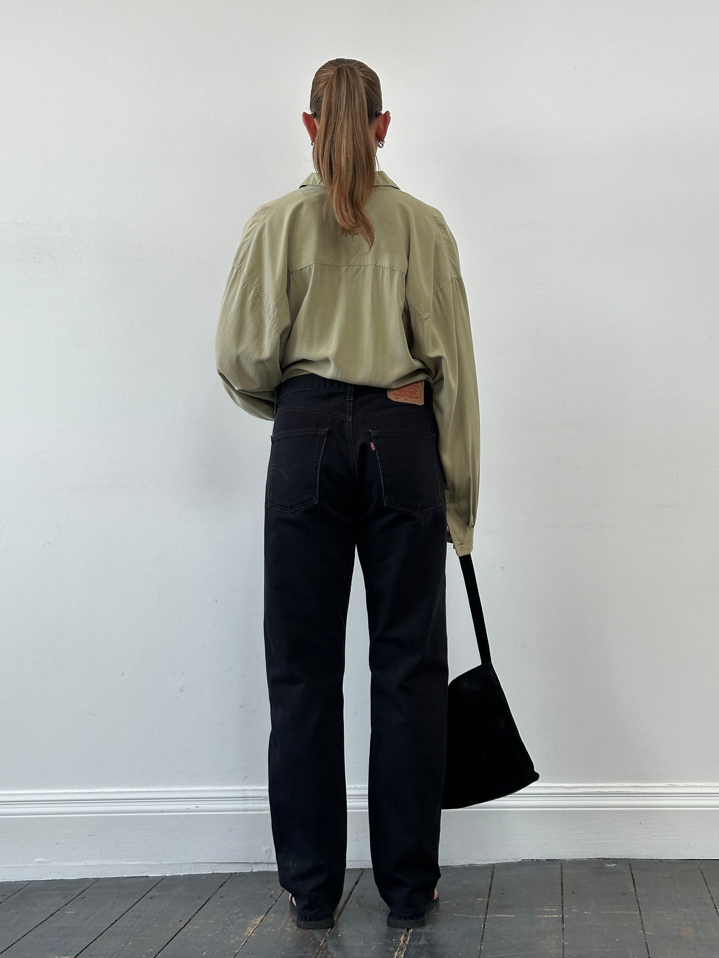 Levi’s 521 tapered straight leg denim jeans in W31, displayed flat showing classic blue cotton fabric and stitching details.