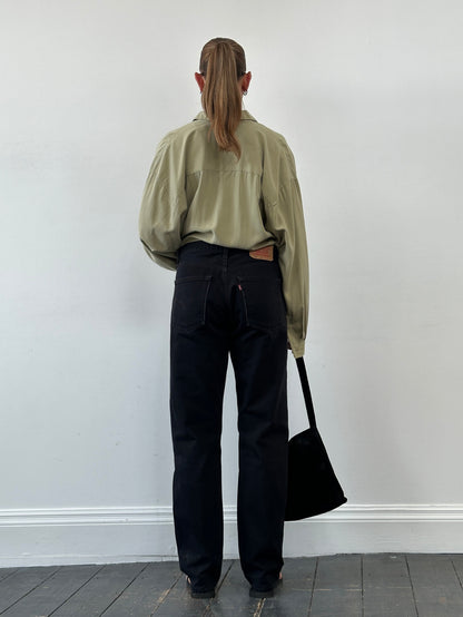 Levi’s 521 tapered straight leg denim jeans in W31, displayed flat showing classic blue cotton fabric and stitching details.