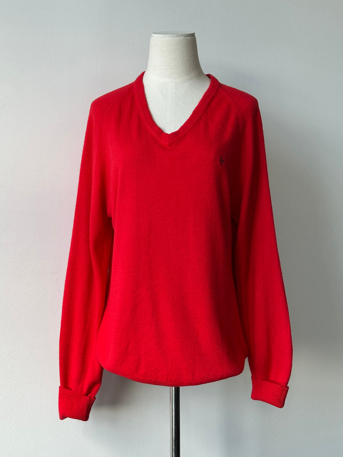 Christian Dior 1990s V-neck logo jumper in black, featuring the Dior brand logo on the front, displayed on a mannequin.