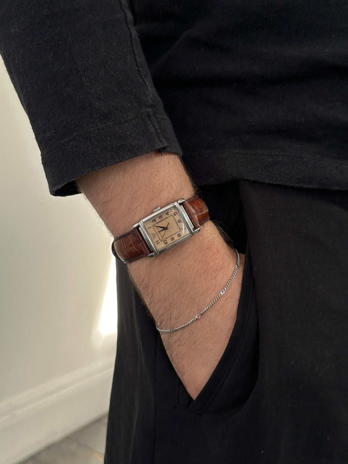 Emporio Armani 2000s leather rectangular quartz watch with silver dial and brown leather strap, close-up of the timepiece.