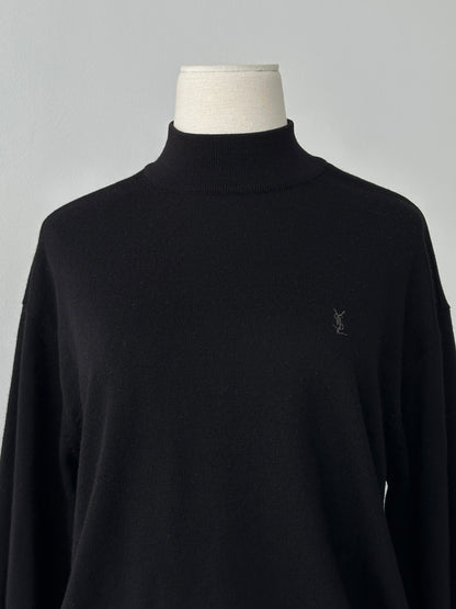 Yves Saint Laurent 1990s wool high neck jumper in black, featuring a classic fit and ribbed collar, displayed on a hanger.