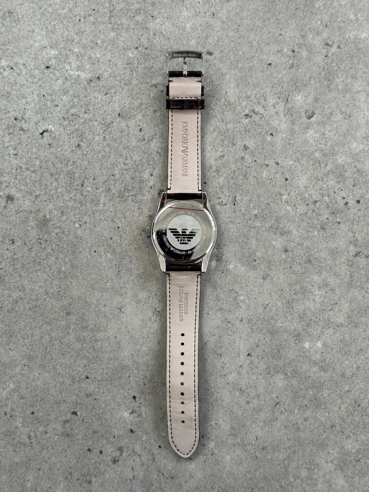Emporio Armani 2000s leather quartz watch with round dial, sleek design, and leather strap, showcasing elegant craftsmanship.