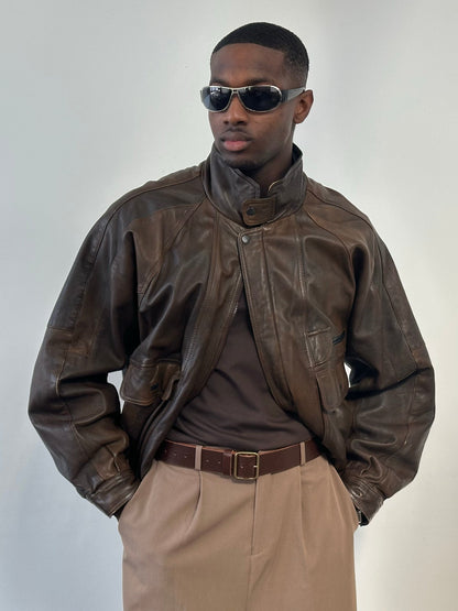 Vintage 1990s leather high-neck bomber jacket in XL, featuring classic leather texture and high collar, styled for a retro look.