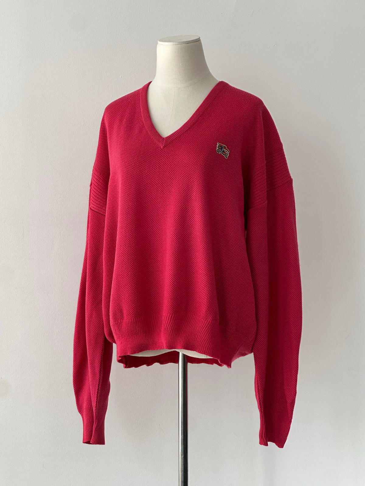 Burberry 1980s V neck logo knit jumper in size L, featuring classic Burberry pattern and ribbed V neckline on a model.