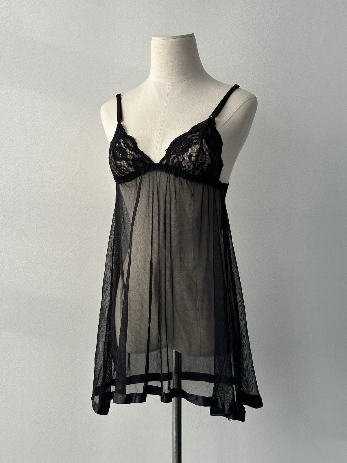 Vintage 2000s sheer sleeveless babydoll top, lightweight and flowy, with delicate fabric and a relaxed fit.