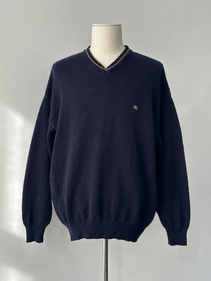 Burberry 1990s pure wool V-neck jumper in XL, featuring classic design and soft wool fabric, displayed on a hanger.