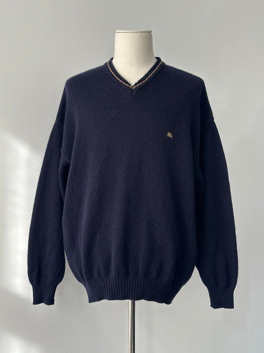 Burberry 1990s pure wool V-neck jumper in XL, featuring classic design and soft wool fabric, displayed on a hanger.
