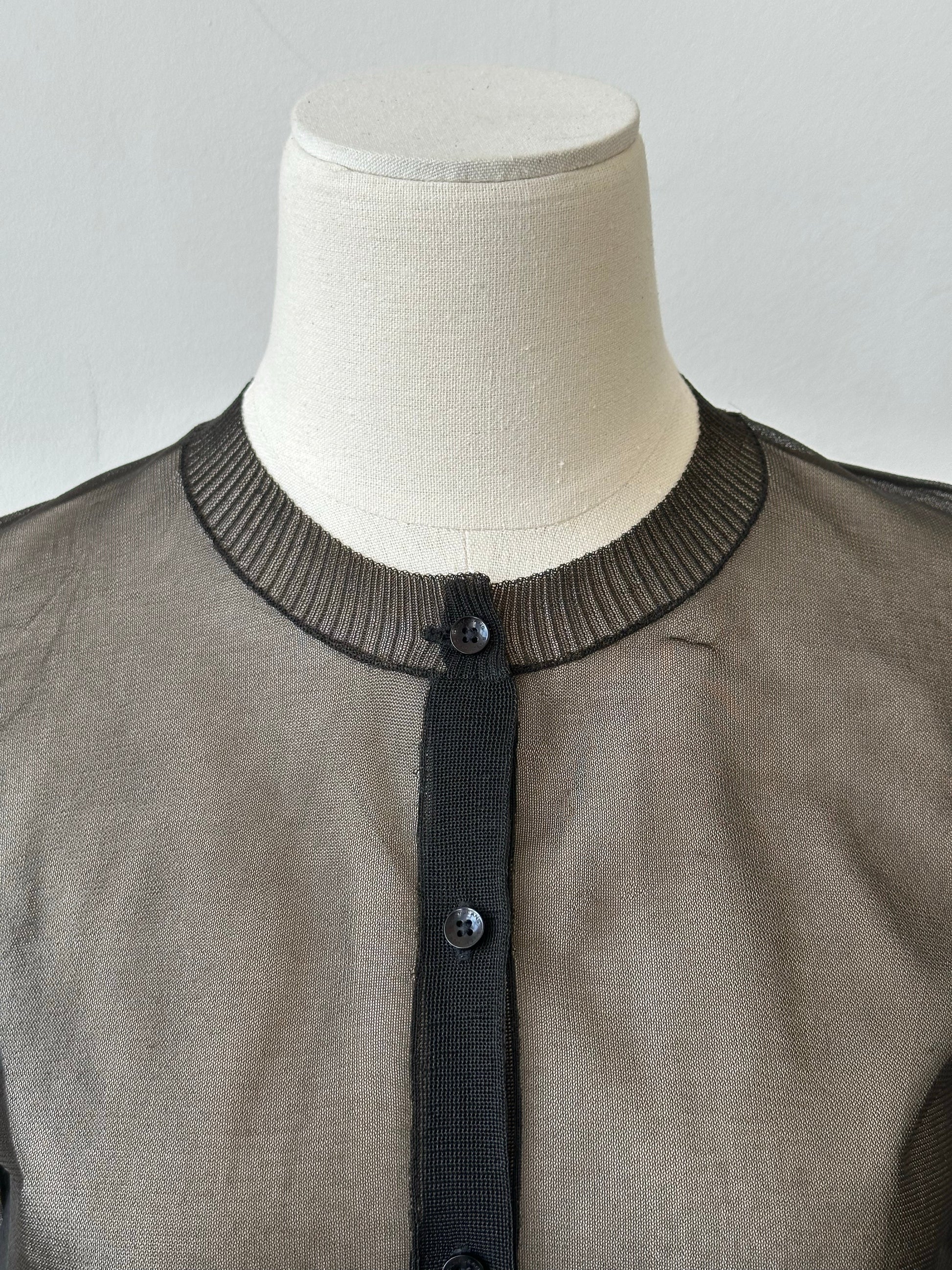 DKNY 1990s sheer knit cardigan in size S, featuring lightweight, transparent fabric and classic design, displayed on a hanger.