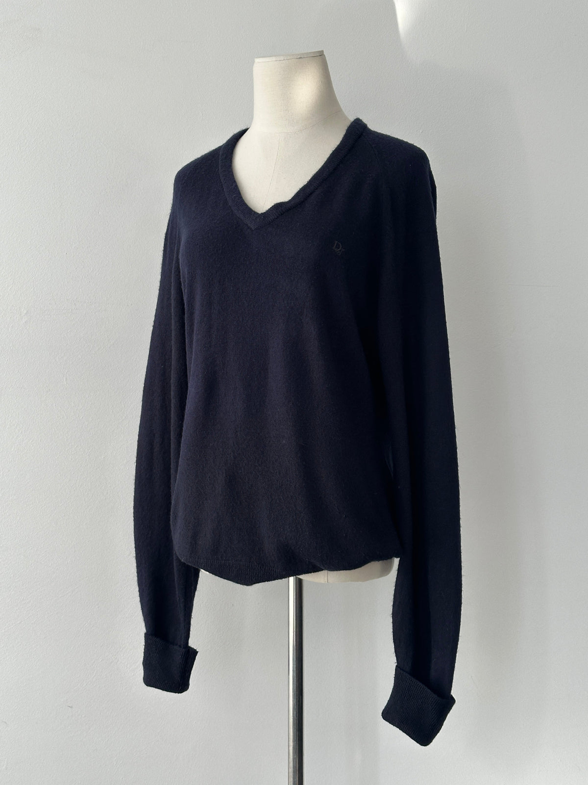 Christian Dior 1990s V-neck logo jumper in black, featuring the iconic Dior branding and classic fit, styled on a mannequin.