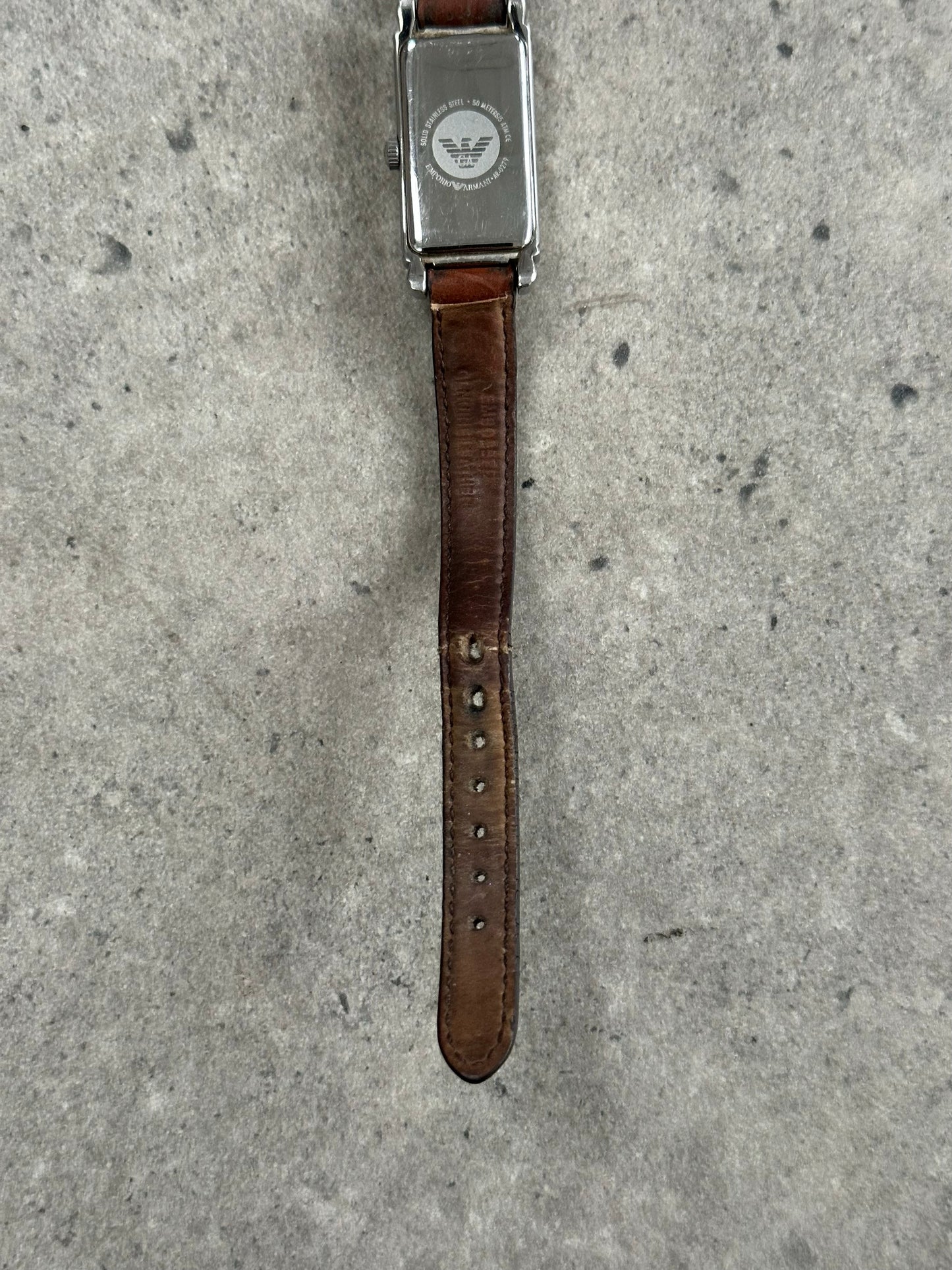 Emporio Armani leather watch with classic design, stainless steel case, and black leather strap, 2000s style and elegant details.