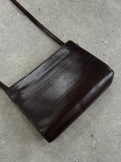Giorgio Armani Le Collezioni 1990s leather crossbody bag with adjustable strap and classic design, in a neutral color.