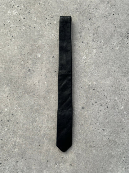 Italian vintage 1990s slim leather tie with a rich brown finish, showcasing a sleek, classic design and detailed stitching.