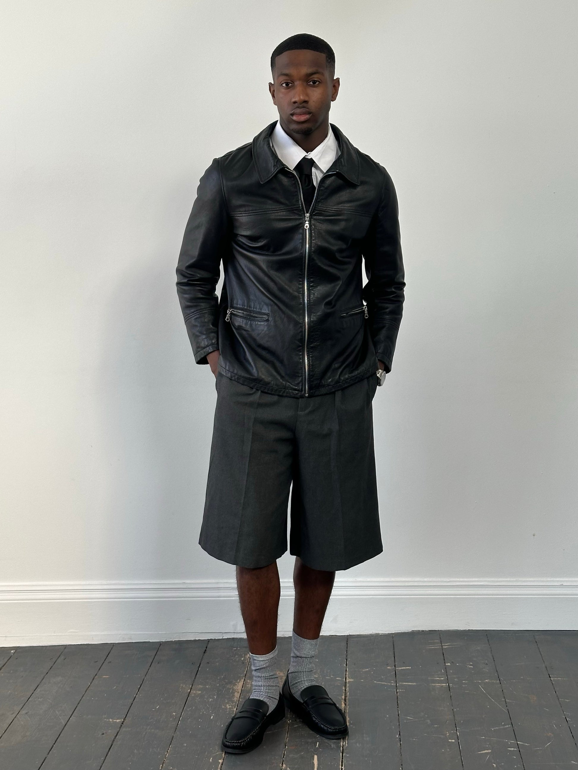 Vintage 1990s leather boxy jacket with classic design, brown leather, and collar detail, size medium.