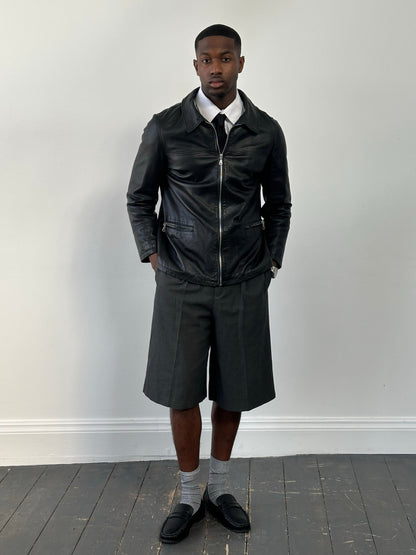 Vintage 1990s leather boxy jacket with classic design, brown leather, and collar detail, size medium.